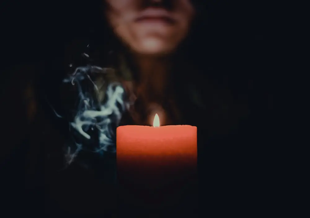 woman-holding-lit-candle